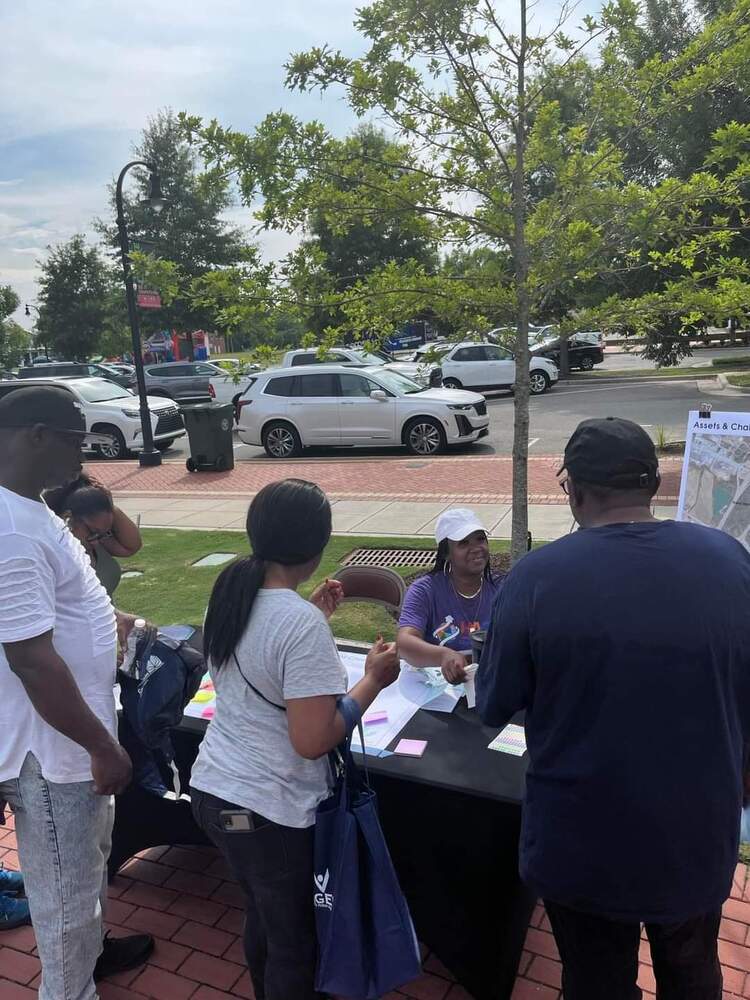 Attendees around a vendor table at event