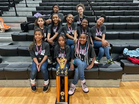 hacg hornet cheerleaders with first place trophy on bleachers.jpg