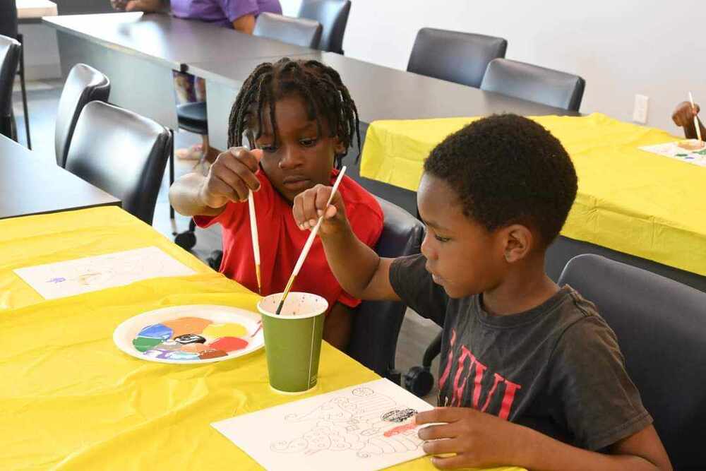 Two young boys at a table with watercolors